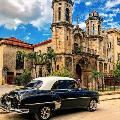 Vintage taxi in front of church in Havana, Cuba