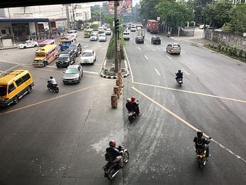 Motorcyclists ride through traffic 